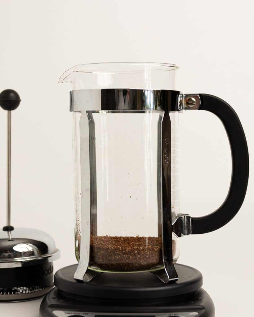 grounds in the bottom of a French press base on a scale 