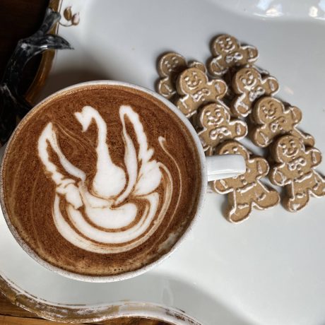 Latte with Gingerbread cookies on a white tray