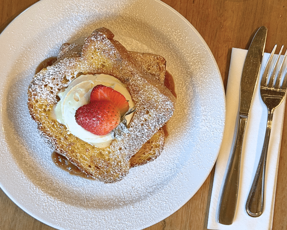 french toast with mascarpone on plate with silverware